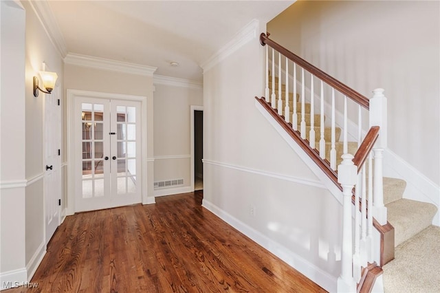 stairway featuring hardwood / wood-style flooring, ornamental molding, and french doors