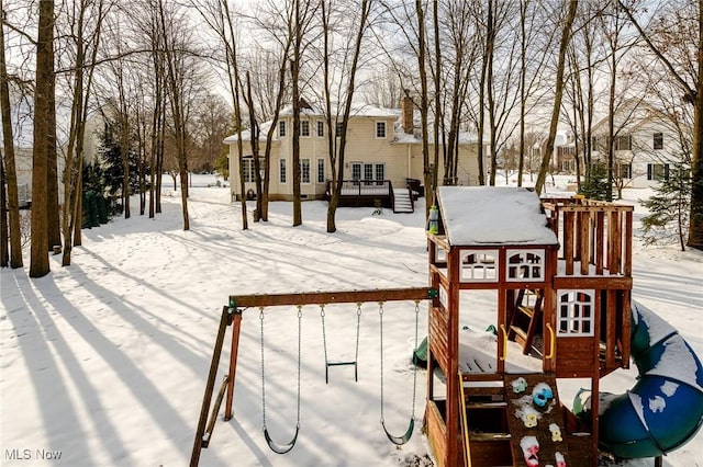 snow covered deck with a playground