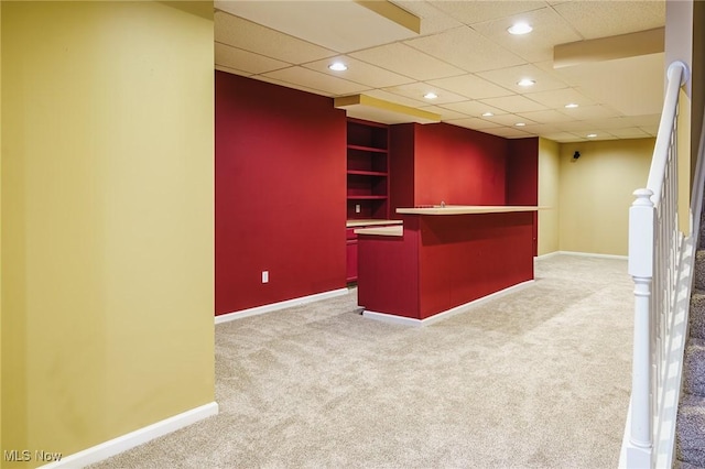 bar featuring carpet flooring and a paneled ceiling