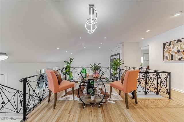 living area with vaulted ceiling and light hardwood / wood-style floors