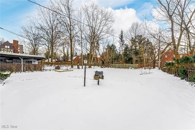 view of yard layered in snow