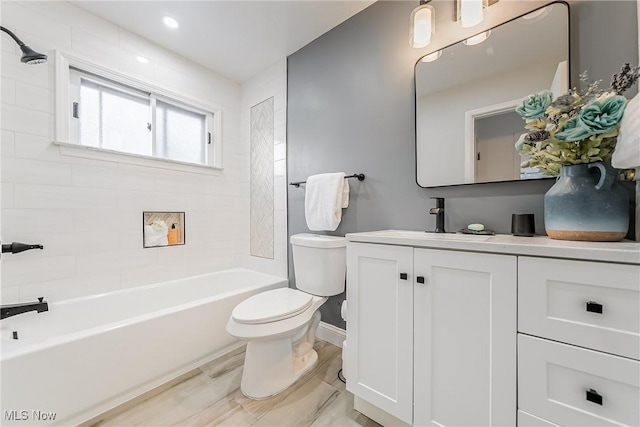 full bathroom with hardwood / wood-style floors, vanity, toilet, and tiled shower / bath