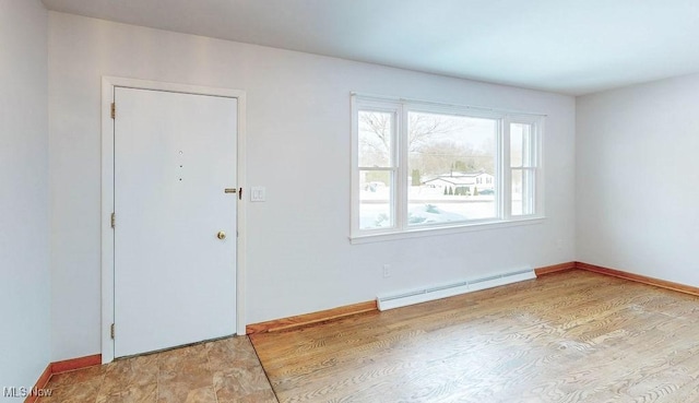 foyer featuring light wood-type flooring and baseboard heating