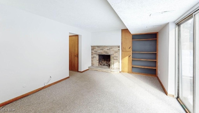 unfurnished living room with a textured ceiling and a fireplace