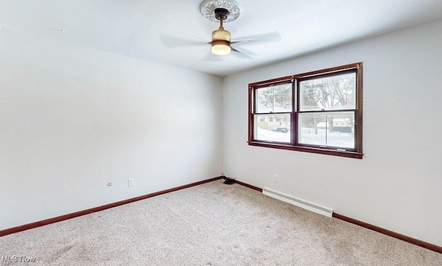 empty room with ceiling fan, baseboard heating, and carpet