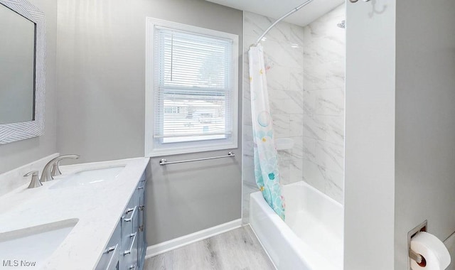 bathroom featuring wood-type flooring, vanity, and shower / tub combo with curtain