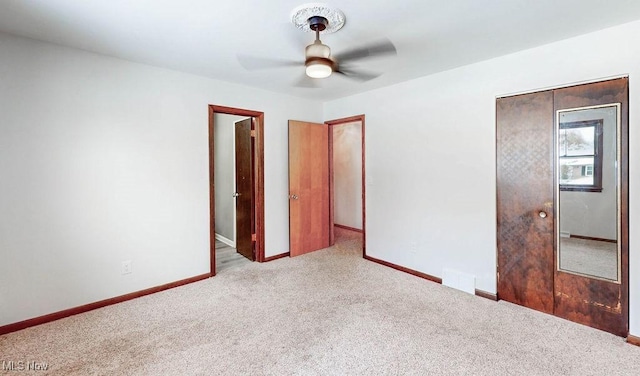 unfurnished bedroom with a closet, ceiling fan, and light colored carpet