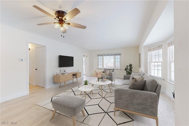 living room featuring ceiling fan and light hardwood / wood-style flooring