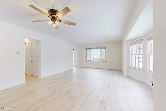 empty room featuring light hardwood / wood-style floors, plenty of natural light, and ceiling fan