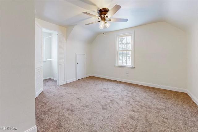 bonus room with ceiling fan, light colored carpet, and lofted ceiling