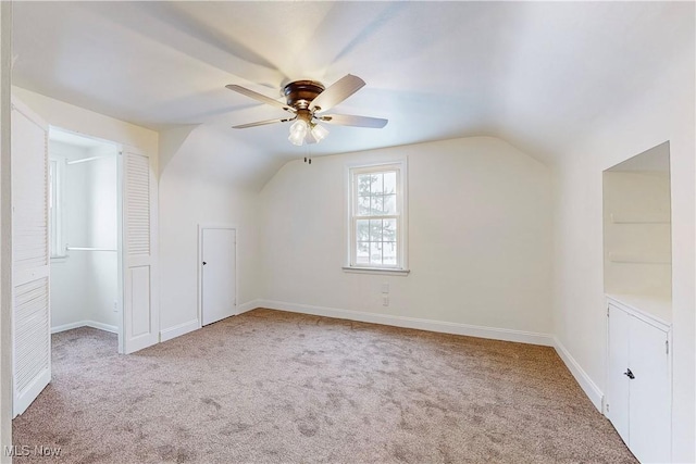 bonus room featuring ceiling fan, light colored carpet, and lofted ceiling