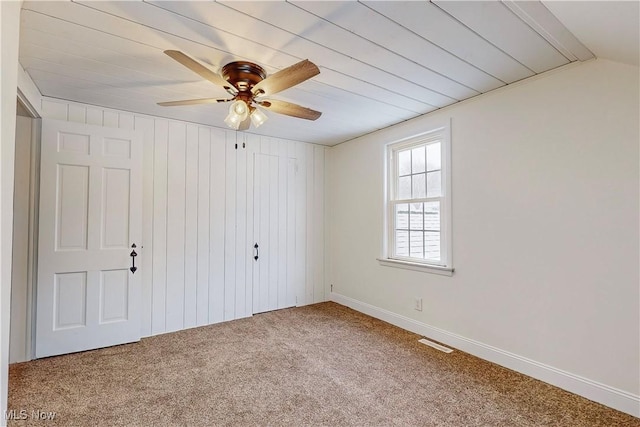 unfurnished bedroom with carpet, a closet, and ceiling fan