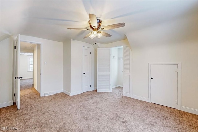 unfurnished bedroom with ceiling fan and light carpet