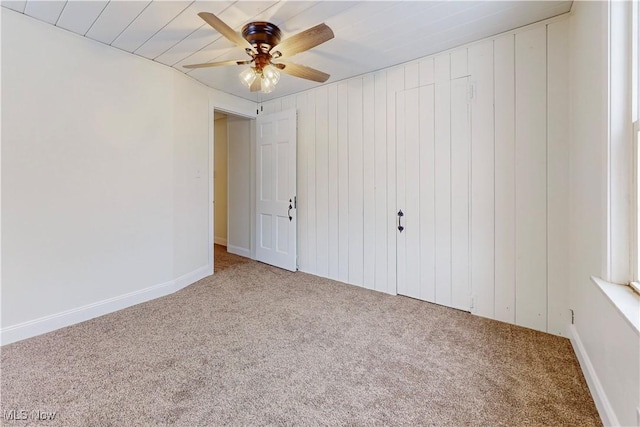 unfurnished bedroom featuring ceiling fan and carpet flooring