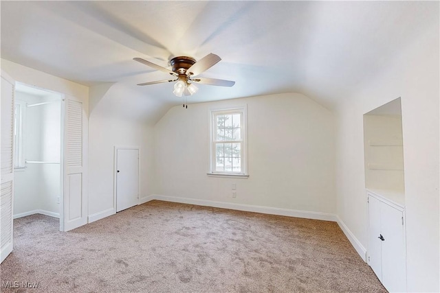 bonus room with ceiling fan, light colored carpet, and lofted ceiling