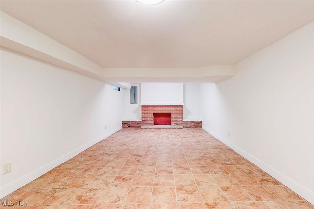 unfurnished living room with electric panel and a brick fireplace