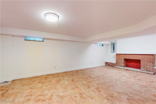 basement featuring a brick fireplace