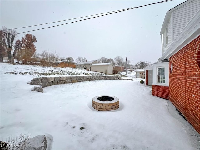 yard covered in snow featuring a fire pit