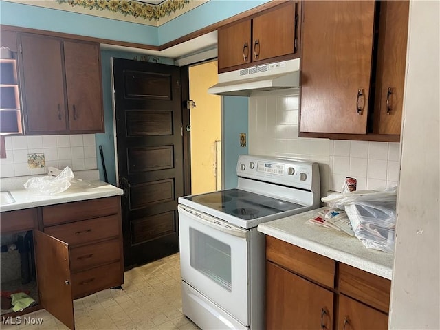 kitchen featuring backsplash and white electric range