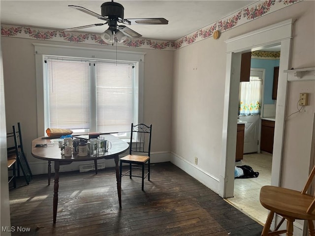 dining space featuring ceiling fan and dark hardwood / wood-style floors