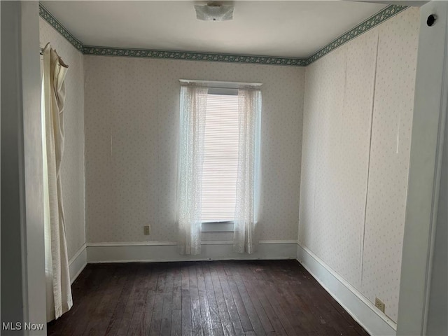 spare room with dark hardwood / wood-style flooring