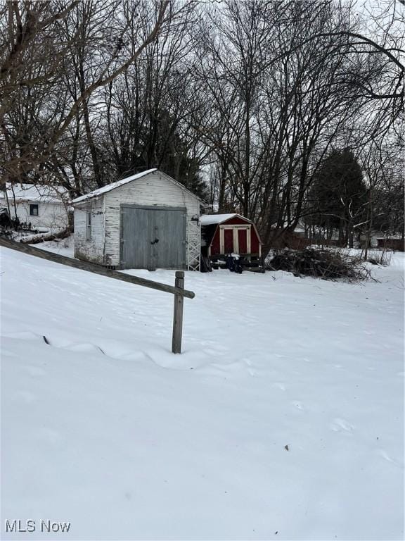 yard covered in snow with a shed