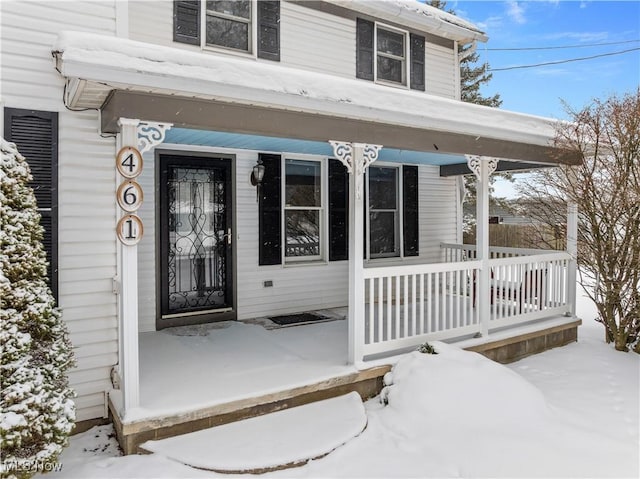 view of snow covered property entrance