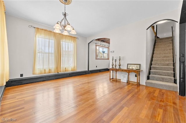 interior space featuring light wood-type flooring and an inviting chandelier