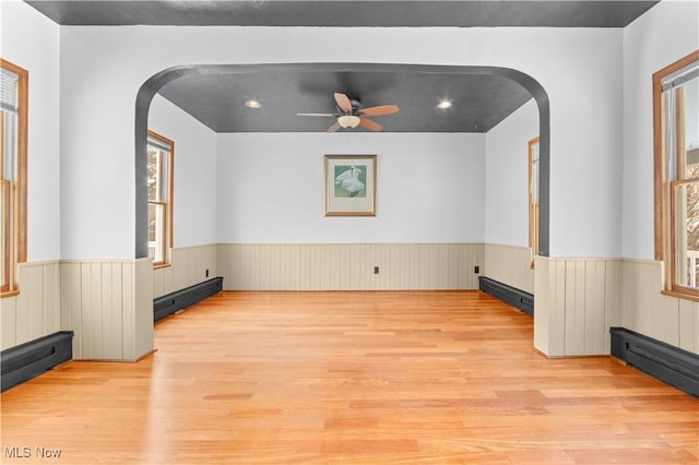 unfurnished living room with ceiling fan and light hardwood / wood-style flooring