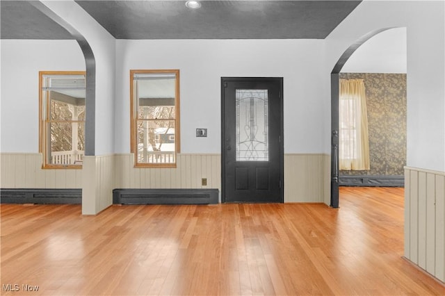 foyer featuring light wood-type flooring and a baseboard radiator