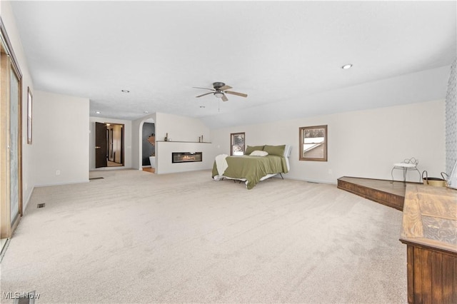 carpeted bedroom featuring lofted ceiling and ceiling fan