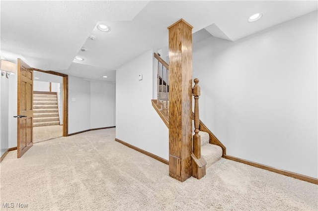 corridor featuring light colored carpet