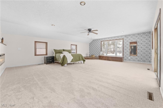 carpeted bedroom featuring vaulted ceiling and ceiling fan