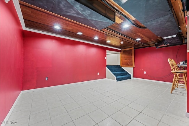 basement with wood ceiling and light tile patterned floors