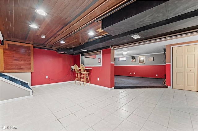 basement with indoor bar and wood ceiling