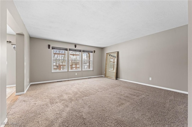 carpeted spare room featuring a textured ceiling