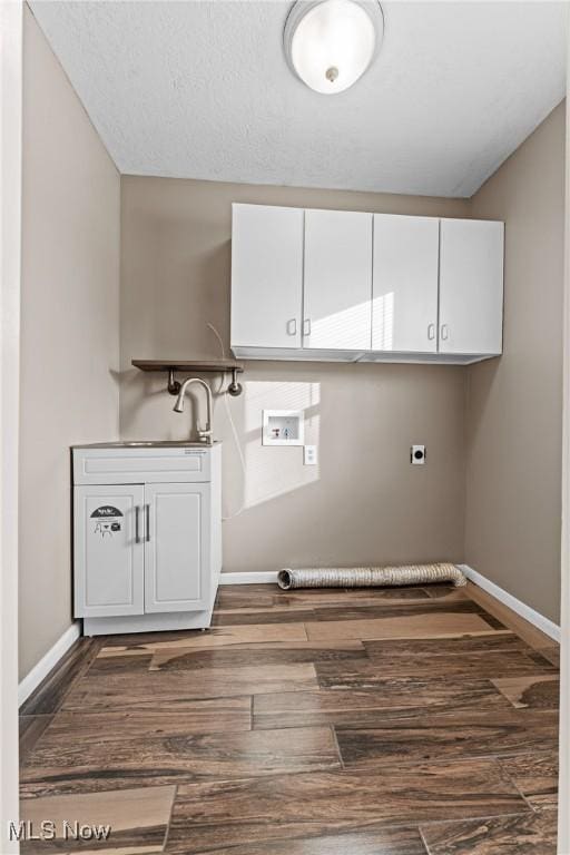 washroom with sink, hookup for a washing machine, electric dryer hookup, dark hardwood / wood-style floors, and cabinets