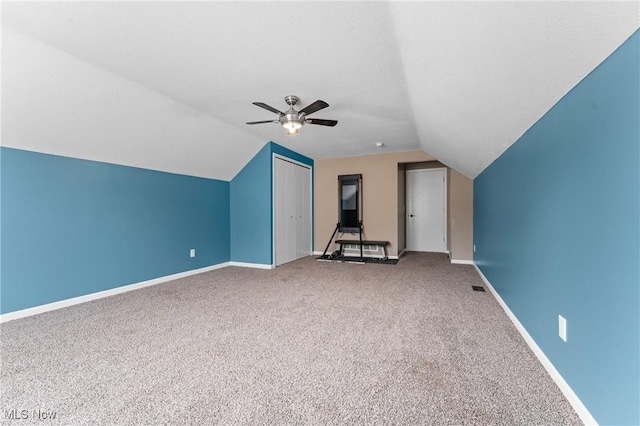 additional living space with ceiling fan, carpet, and lofted ceiling