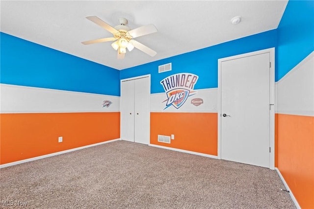 interior space with carpet flooring and ceiling fan