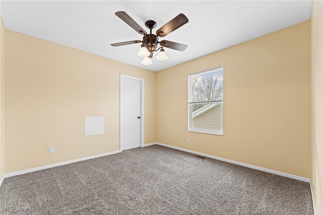 carpeted spare room with ceiling fan