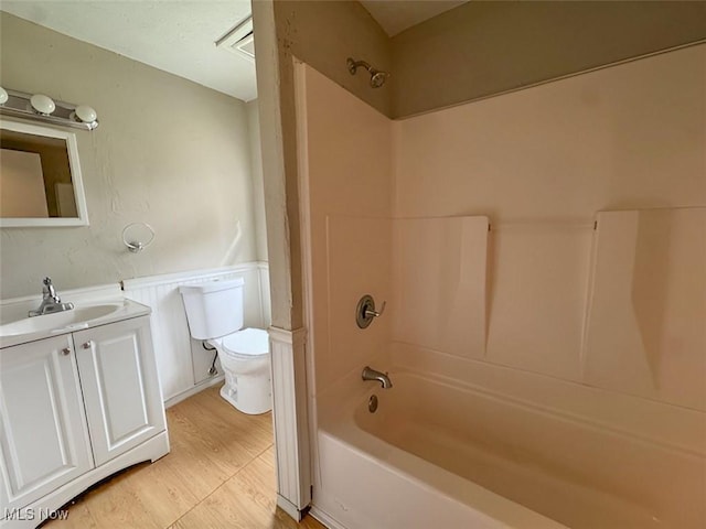 full bathroom featuring hardwood / wood-style floors, toilet, vanity, and bathing tub / shower combination