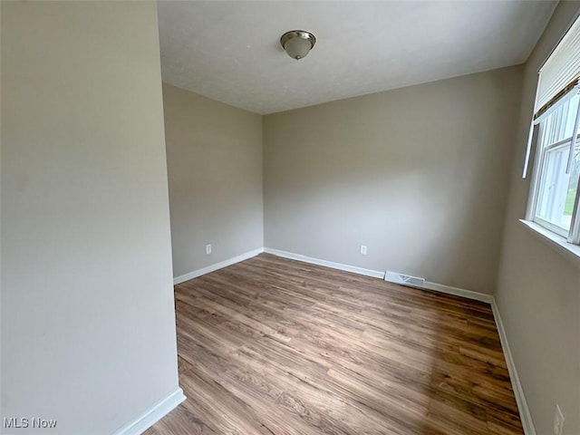 spare room featuring hardwood / wood-style floors