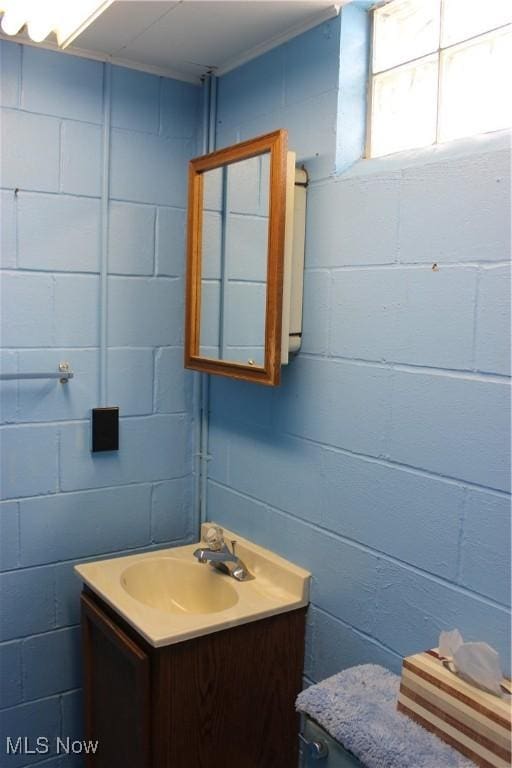 bathroom with ornamental molding and vanity