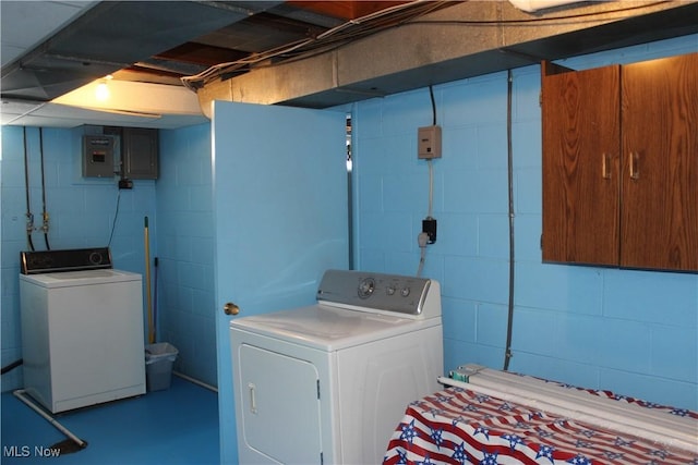 washroom featuring laundry area, washing machine and dryer, and electric panel