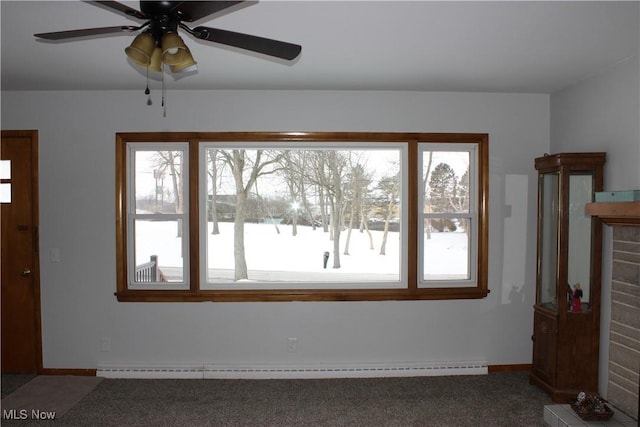 interior space featuring ceiling fan, a baseboard heating unit, and carpet floors