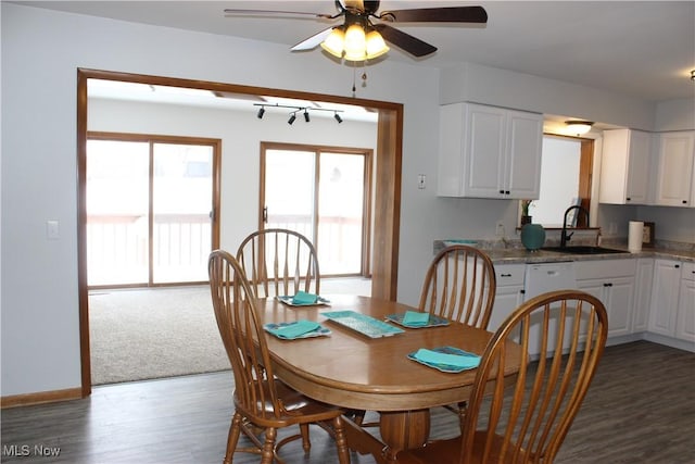 dining space with ceiling fan, dark wood-style flooring, and baseboards