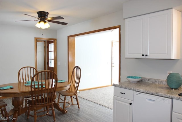 dining space with wood-type flooring and ceiling fan