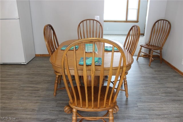 dining room featuring dark wood-style floors and baseboards