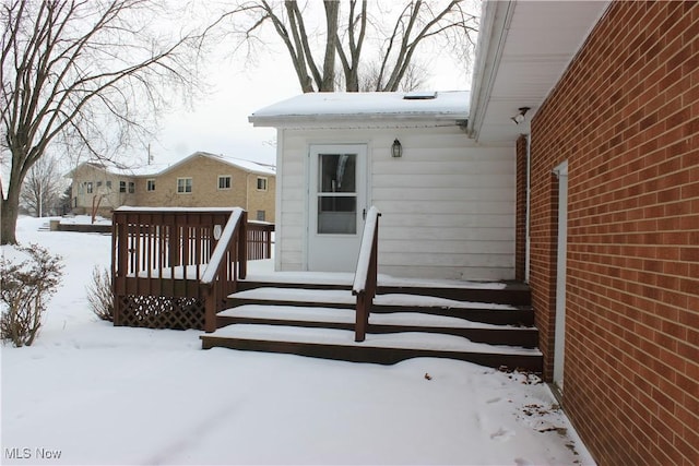 view of snow covered property entrance