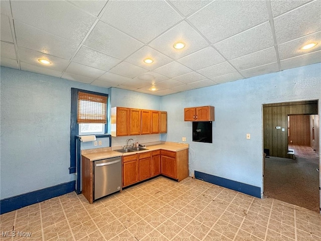 kitchen featuring sink, a drop ceiling, and dishwasher